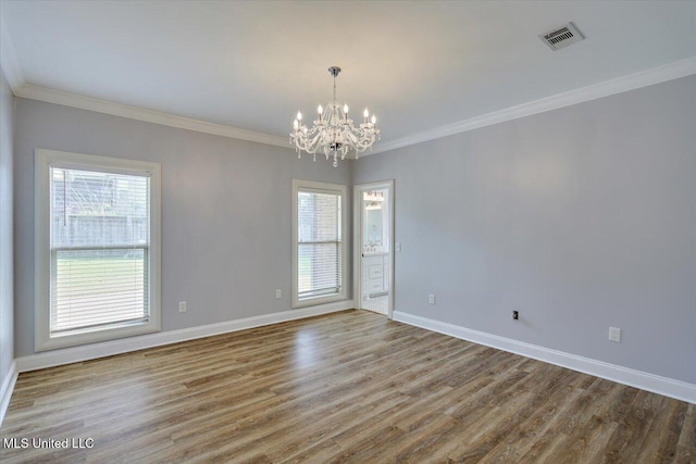 306 Canebreak Cv, Madison, MS 39110 - empty room featuring a chandelier, healthy amount of natural light, wood finished floors, baseboards, and ornamental molding