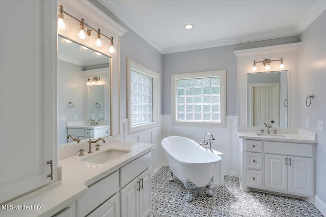 306 Canebreak Cv, Madison, MS 39110 - full bath with wainscoting, a freestanding bath, two vanities, ornamental molding, and recessed lighting