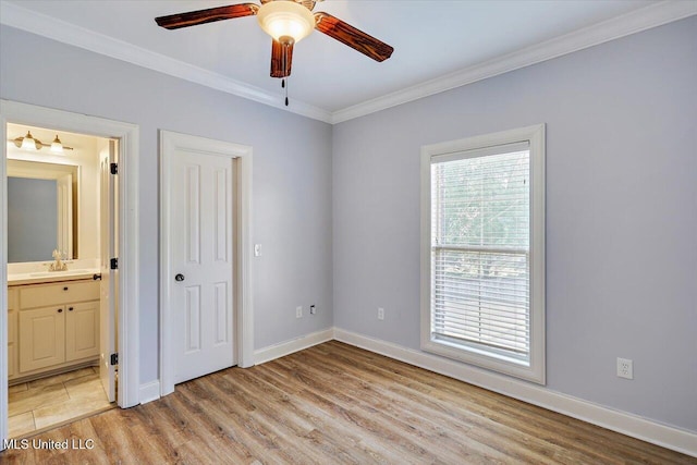 306 Canebreak Cv, Madison, MS 39110 - unfurnished bedroom featuring light wood-style floors, ornamental molding, ensuite bath, baseboards, and a sink