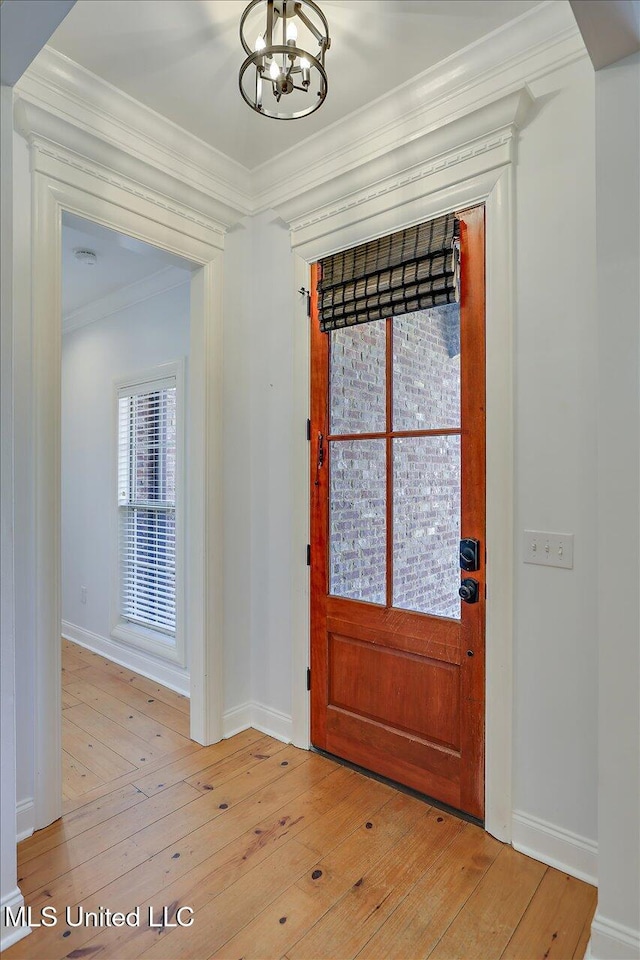 306 Canebreak Cv, Madison, MS 39110 - entrance foyer with a chandelier, light wood finished floors, ornamental molding, and baseboards
