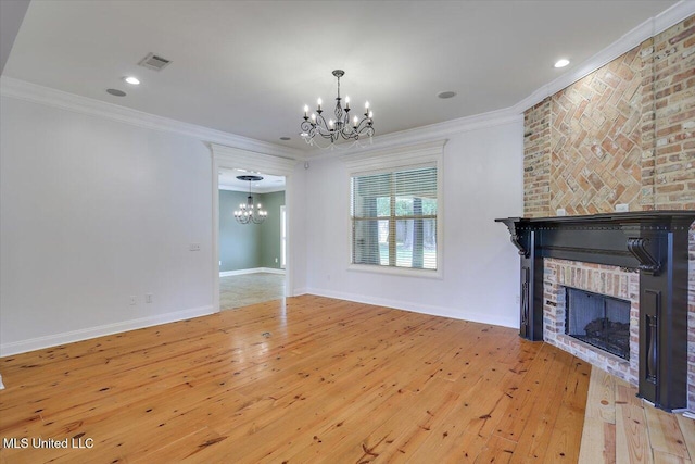 306 Canebreak Cv, Madison, MS 39110 - unfurnished living room featuring a chandelier, a fireplace, hardwood / wood-style flooring, crown molding, and baseboards