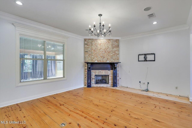 306 Canebreak Cv, Madison, MS 39110 - unfurnished living room featuring a chandelier, crown molding, a fireplace, hardwood / wood-style floors, and baseboards