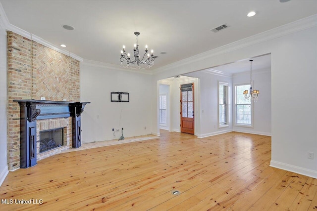 306 Canebreak Cv, Madison, MS 39110 - unfurnished living room featuring a chandelier, wood-type flooring, crown molding, a fireplace, and baseboards