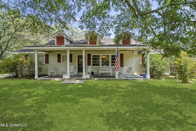 rear view of property featuring a porch and a lawn