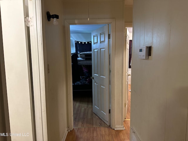 corridor with hardwood / wood-style flooring