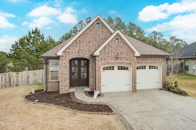 view of front of home with a garage and french doors