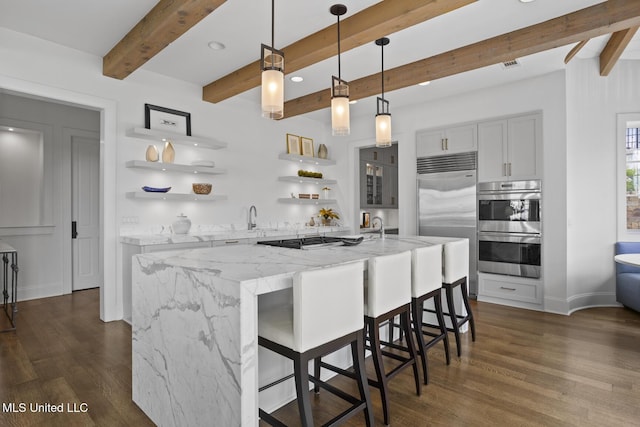 150 Old Trace Rd, Madison, MS 39110 - kitchen with appliances with stainless steel finishes, open shelves, beam ceiling, dark wood-type flooring, and light stone countertops