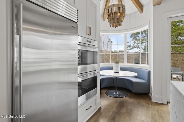 150 Old Trace Rd, Madison, MS 39110 - kitchen with appliances with stainless steel finishes, a chandelier, dark wood-type flooring, breakfast area, and beam ceiling