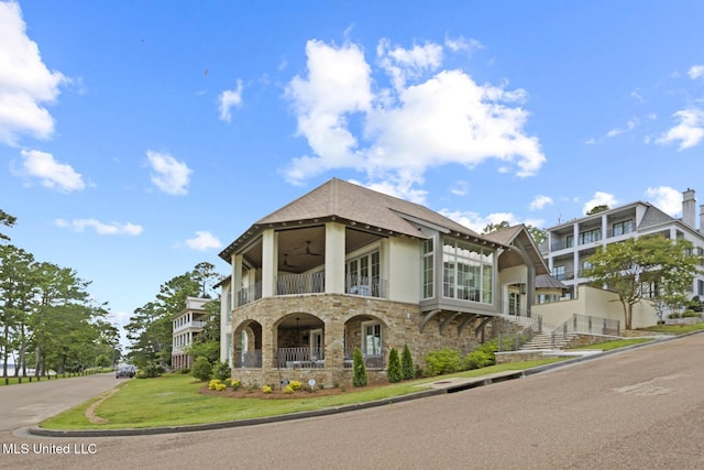150 Old Trace Rd, Madison, MS 39110 - view of front facade featuring stone siding, a balcony, and a ceiling fan