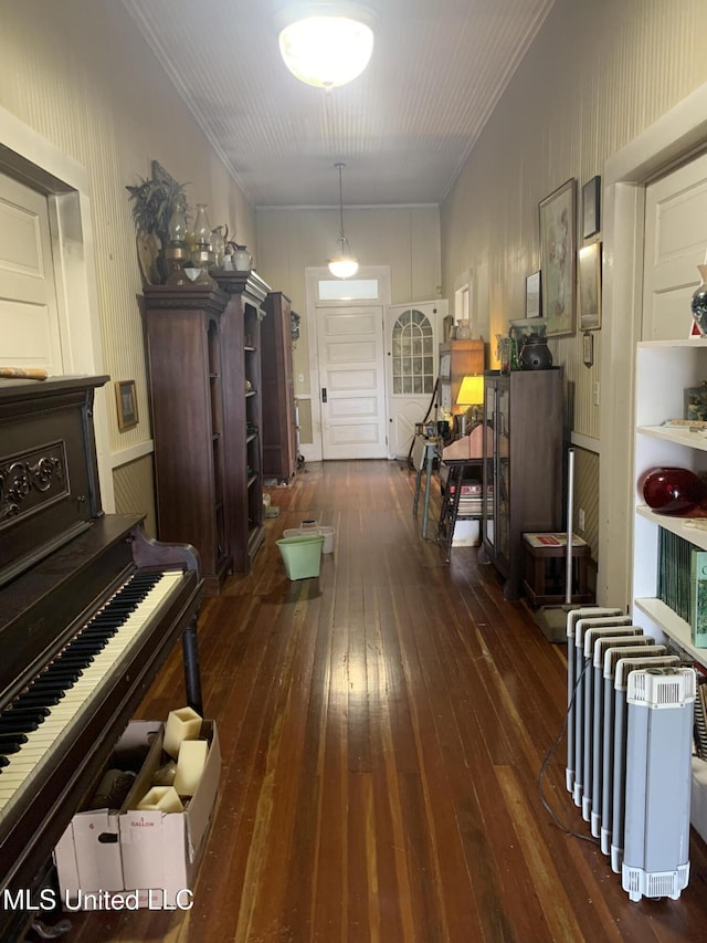 misc room featuring ornamental molding and dark wood-type flooring