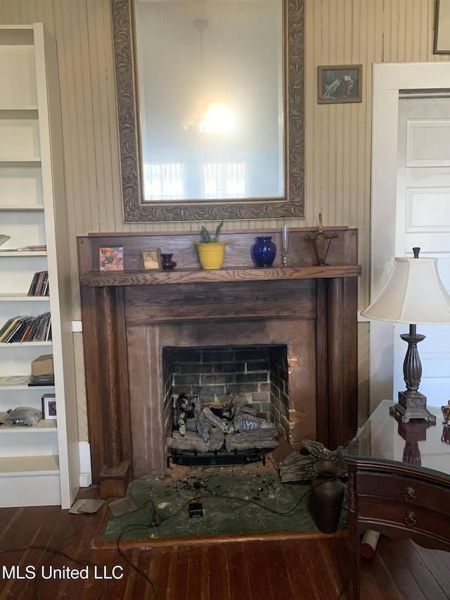 interior details featuring built in shelves and wood-type flooring