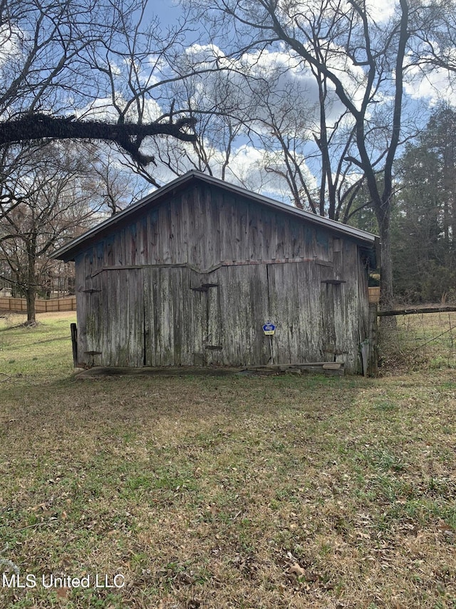 view of outbuilding featuring a yard