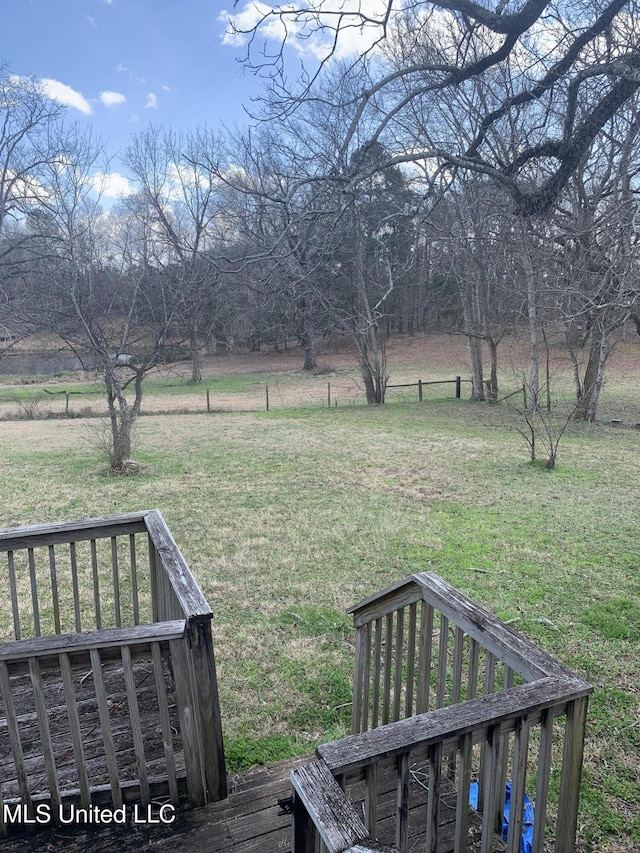 view of yard featuring a wooden deck and a rural view