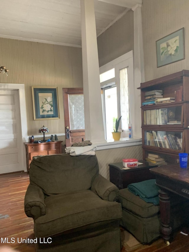 living room with crown molding and hardwood / wood-style floors