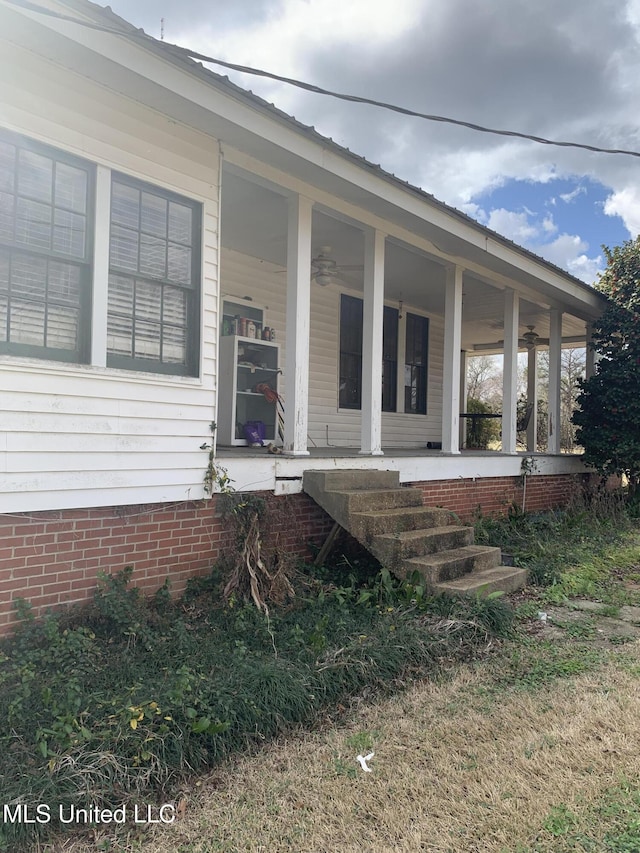 view of exterior entry featuring covered porch