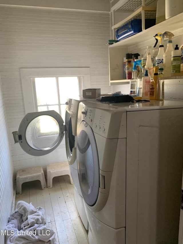 laundry room featuring washing machine and dryer and light wood-type flooring