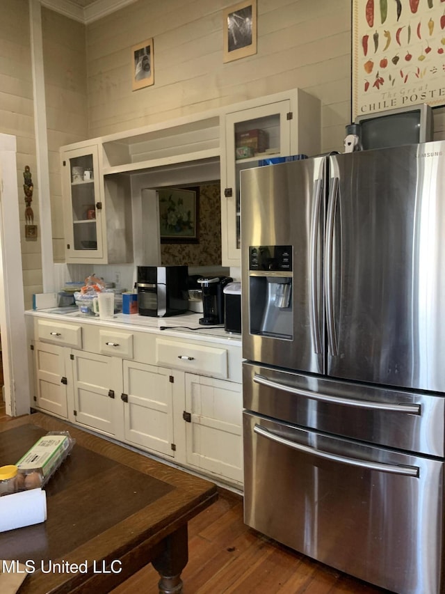 kitchen featuring stainless steel fridge with ice dispenser, dark wood-type flooring, and white cabinets