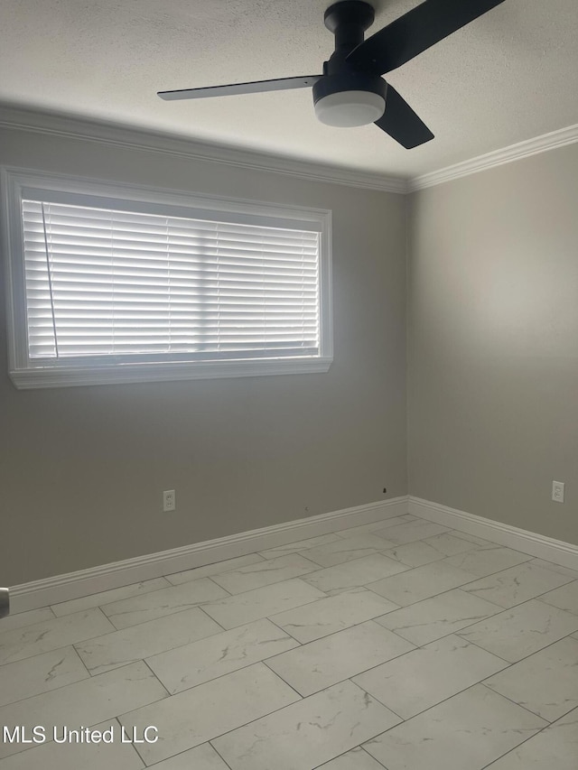 spare room featuring ceiling fan, baseboards, marble finish floor, a wealth of natural light, and crown molding