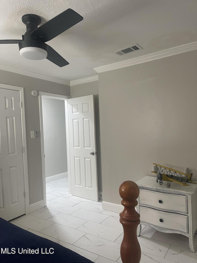 unfurnished bedroom featuring baseboards, visible vents, marble finish floor, a textured ceiling, and crown molding