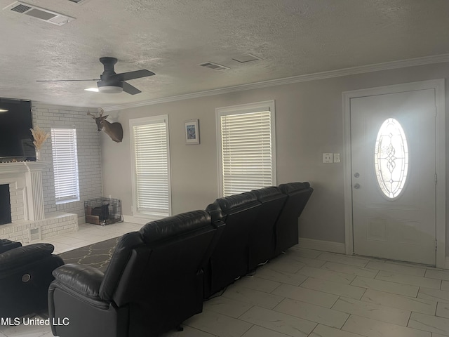 living room with a fireplace, visible vents, and ornamental molding