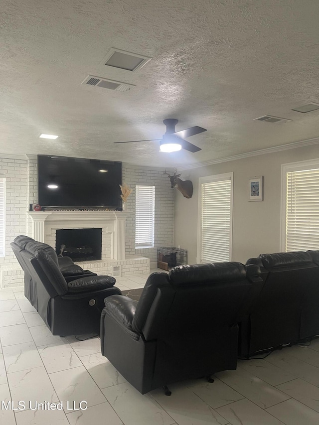 living area featuring marble finish floor, a brick fireplace, visible vents, and ornamental molding