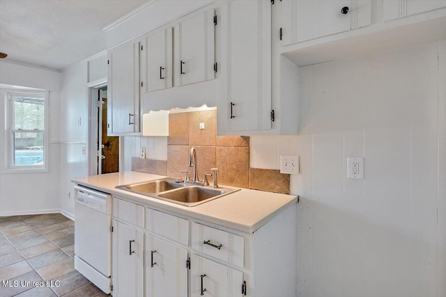 kitchen with white dishwasher, sink, and white cabinets