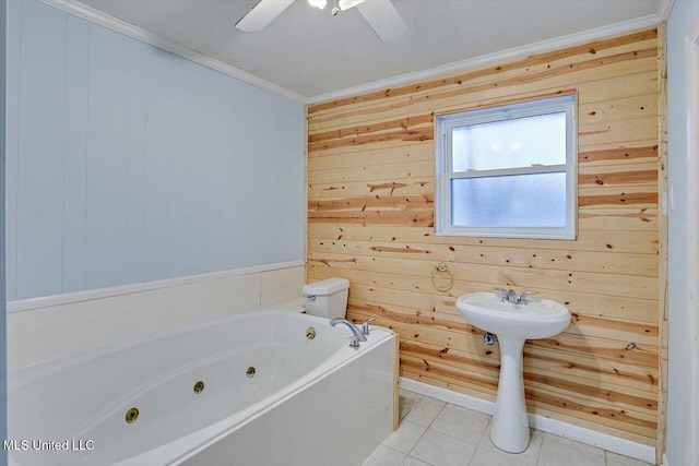 bathroom featuring crown molding, tile patterned floors, wooden walls, and a tub