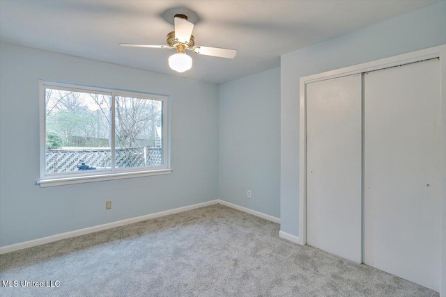 unfurnished bedroom with ceiling fan, light carpet, and a closet