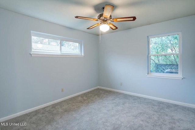 carpeted empty room featuring ceiling fan