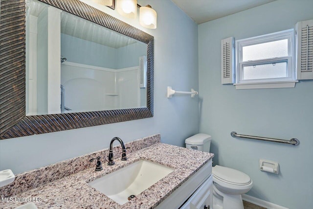 bathroom with vanity, toilet, and walk in shower