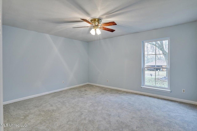 carpeted spare room featuring ceiling fan