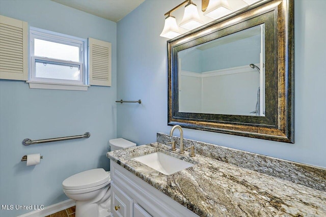 bathroom featuring vanity and toilet