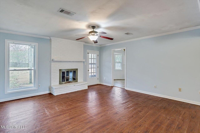 unfurnished living room with ornamental molding, dark wood-type flooring, ceiling fan, and a fireplace