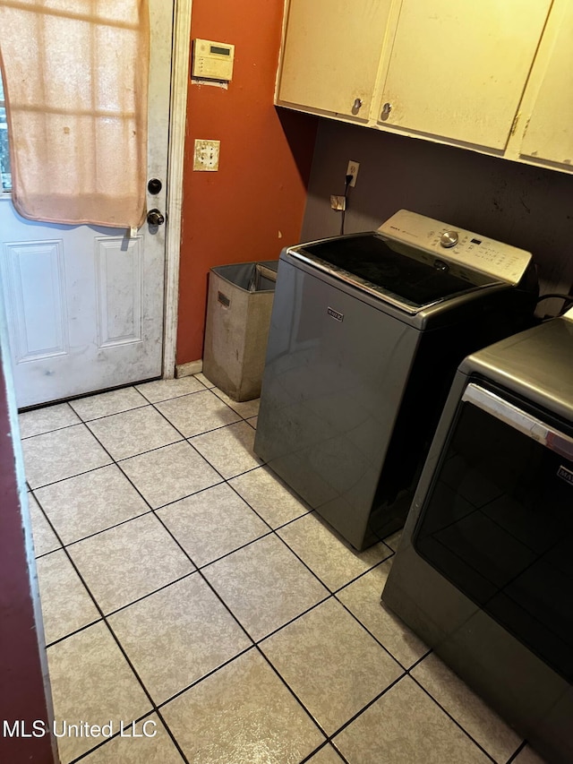 4668 Norway Dr, Jackson, MS 39206 - washroom featuring cabinet space, light tile patterned flooring, and separate washer and dryer