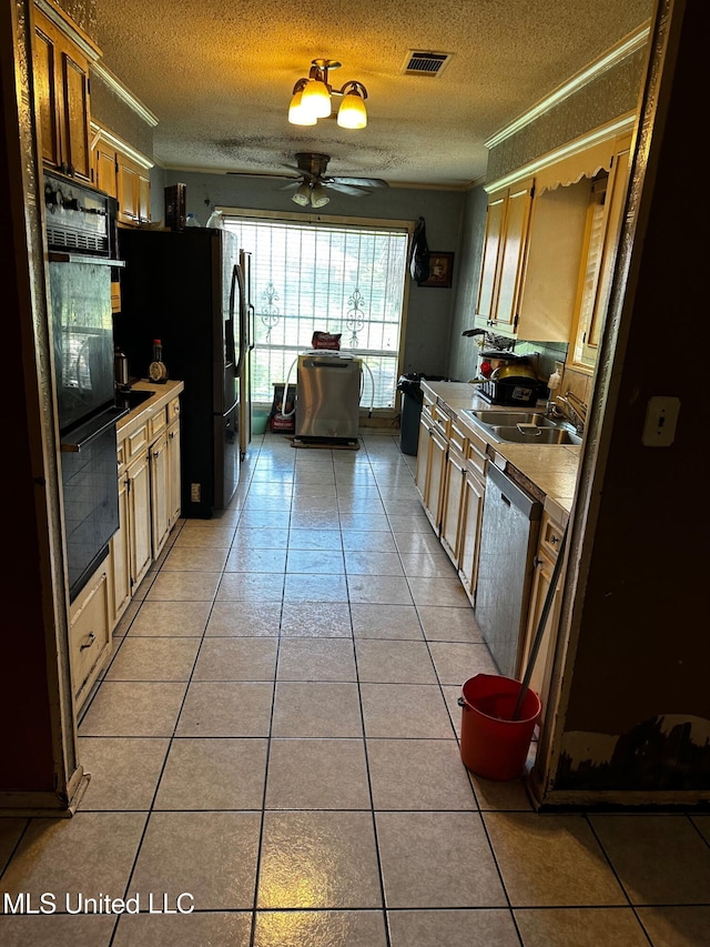 4668 Norway Dr, Jackson, MS 39206 - kitchen featuring appliances with stainless steel finishes, light tile patterned floors, ceiling fan, ornamental molding, and a textured ceiling