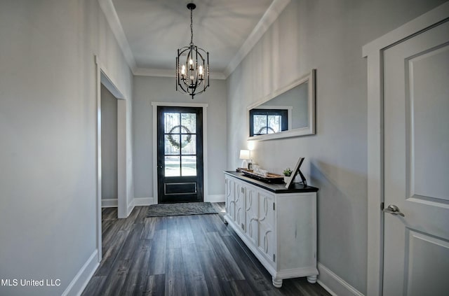 entryway featuring baseboards, a notable chandelier, dark wood finished floors, and crown molding