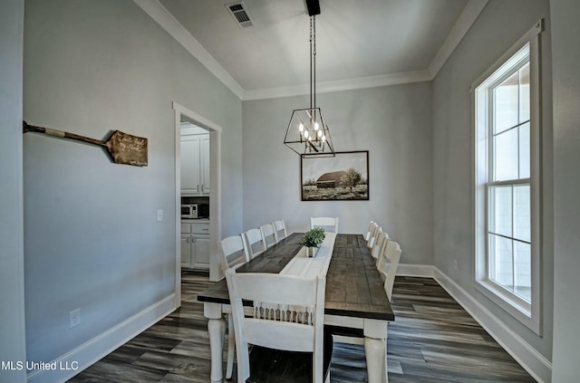 dining area featuring dark wood finished floors, visible vents, a healthy amount of sunlight, and baseboards