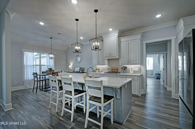 kitchen with dark wood-style floors, decorative backsplash, plenty of natural light, and light countertops