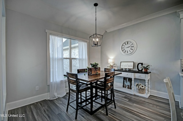 dining space featuring baseboards, an inviting chandelier, and dark wood finished floors