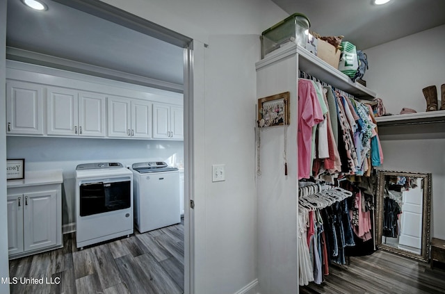 laundry room with recessed lighting, cabinet space, wood finished floors, and washing machine and clothes dryer