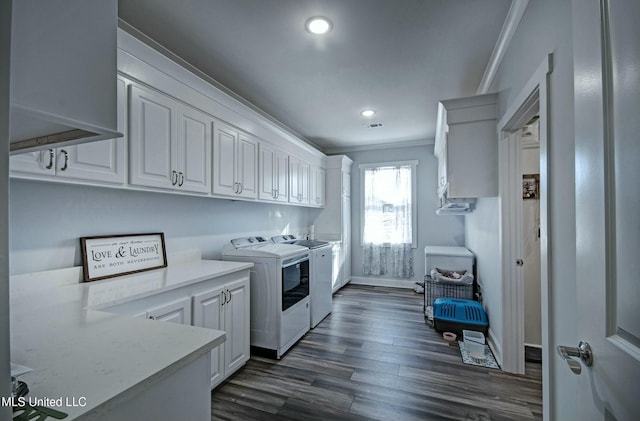 laundry area featuring crown molding, recessed lighting, washer and dryer, cabinet space, and dark wood-style flooring