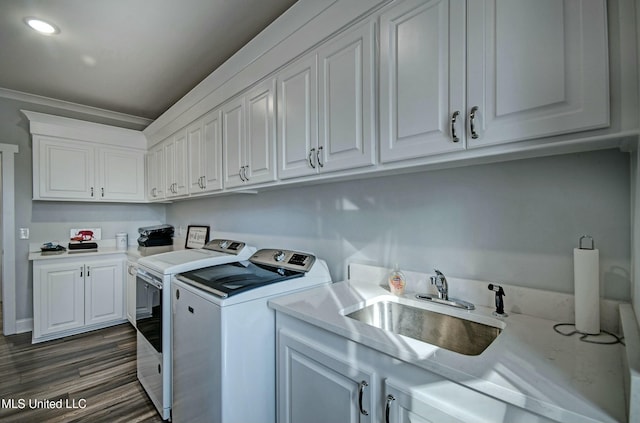 laundry room featuring a sink, recessed lighting, washer and dryer, cabinet space, and dark wood-style flooring