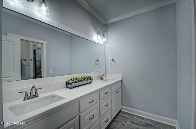 bathroom with double vanity, baseboards, and a sink