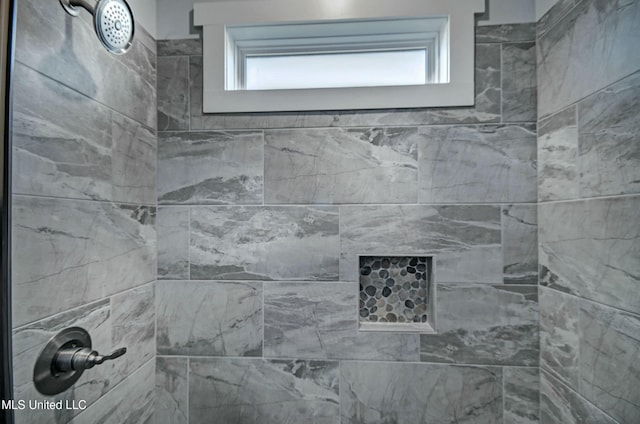 bathroom with a tile shower