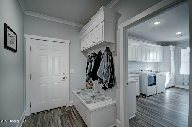 mudroom featuring baseboards, separate washer and dryer, ornamental molding, and dark wood finished floors