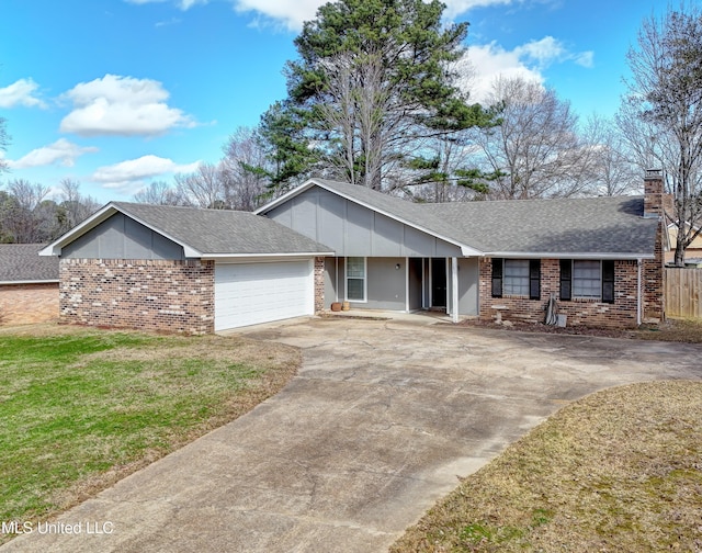 single story home featuring an attached garage, a chimney, a front lawn, brick siding, and driveway