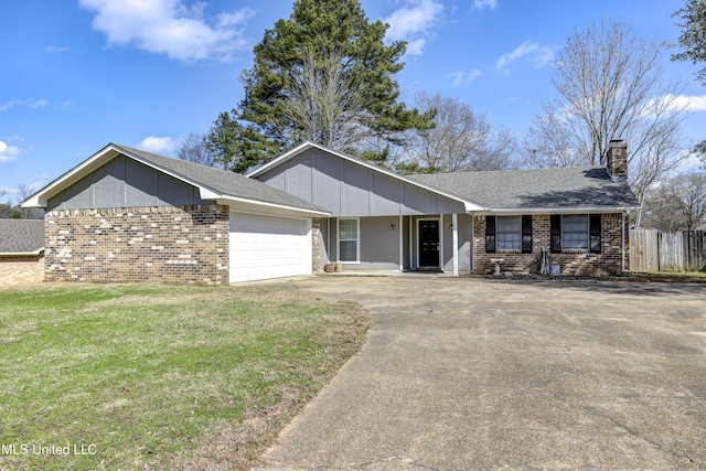 ranch-style home with a chimney, brick siding, an attached garage, and concrete driveway