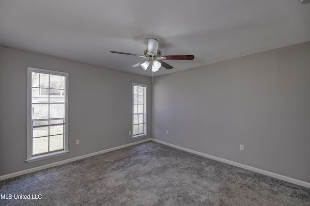 carpeted spare room with ceiling fan and baseboards