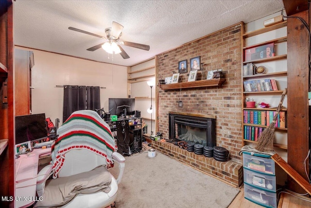 2880 Briarwood Dr, Horn Lake, MS 38637 - living area featuring a ceiling fan, a textured ceiling, a brick fireplace, and carpet floors
