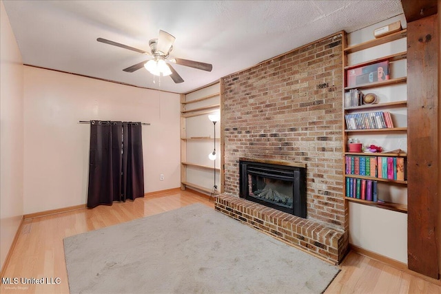 2880 Briarwood Dr, Horn Lake, MS 38637 - unfurnished living room with a brick fireplace, a ceiling fan, and wood finished floors